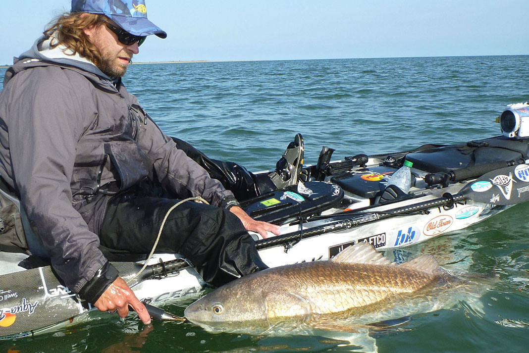 kayak angler releases red drum back into water during Virginia spring run