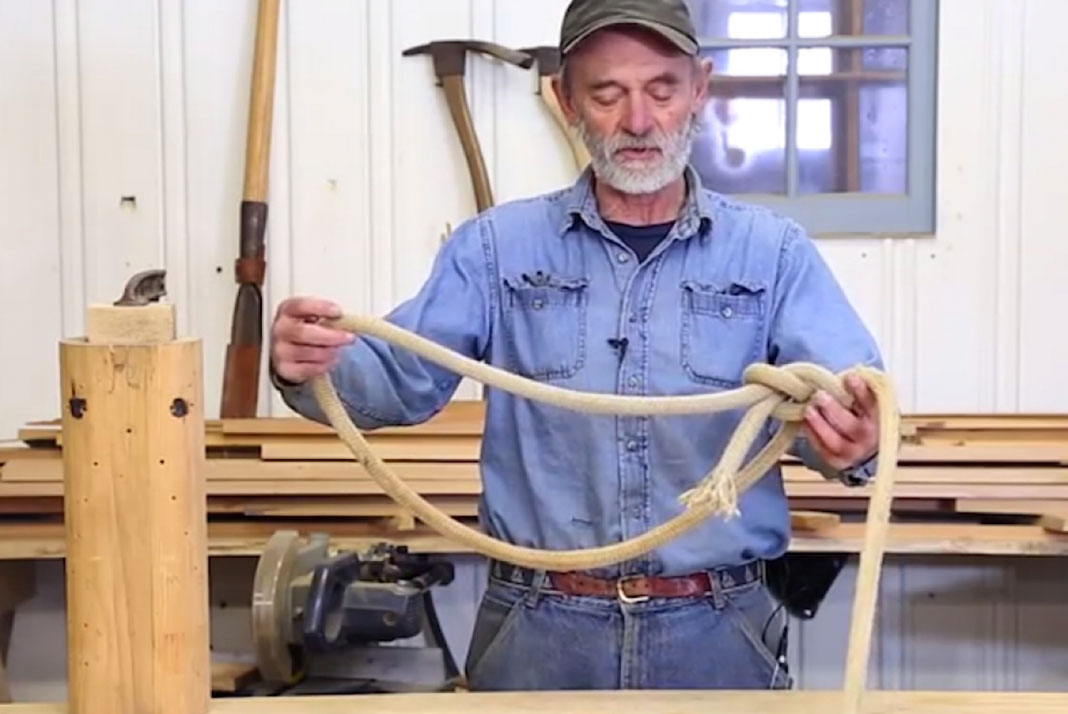 older man in a workshop demonstrates how to tie knots with rope