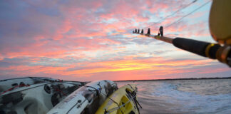 kayaks are tied and transported on a mothership at dawn during a kayak fishing trip