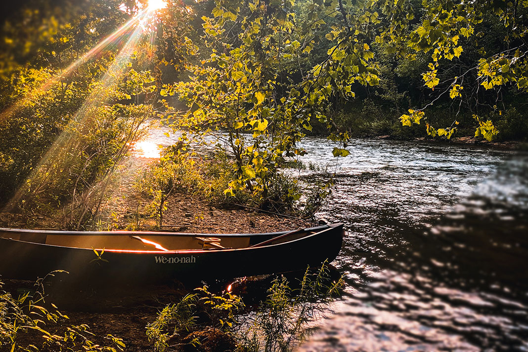 a canoe sits on the riverbank in Alabama