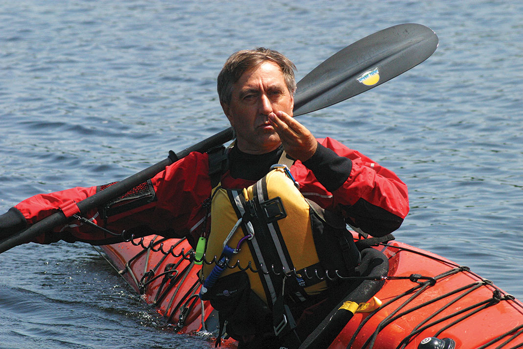 male kayaker demonstrates a one-armed brace