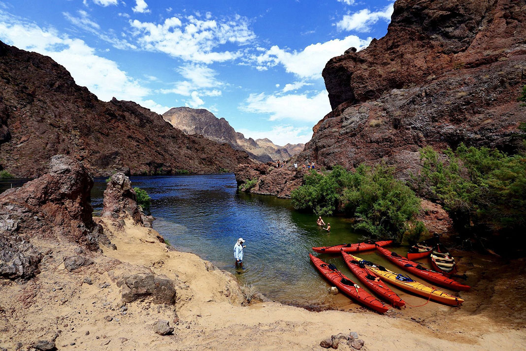 a group of kayakers stop for a rest along the Colorado River
