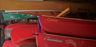 a group of canoes in storage in a garage