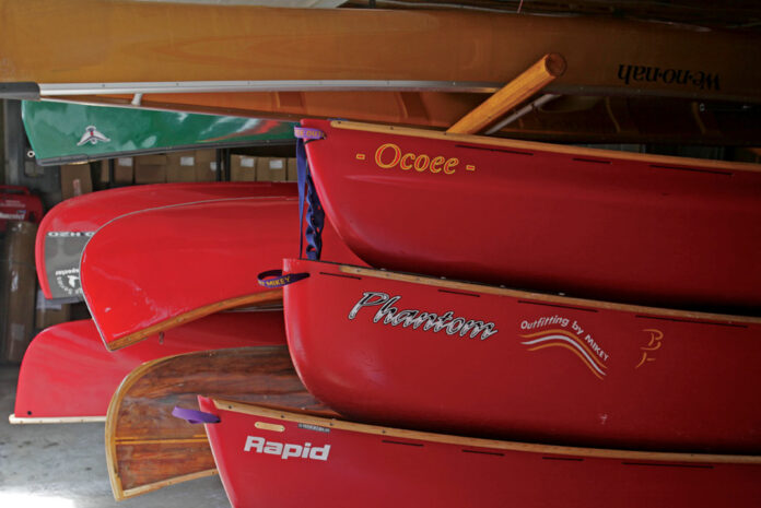a group of canoes in storage in a garage