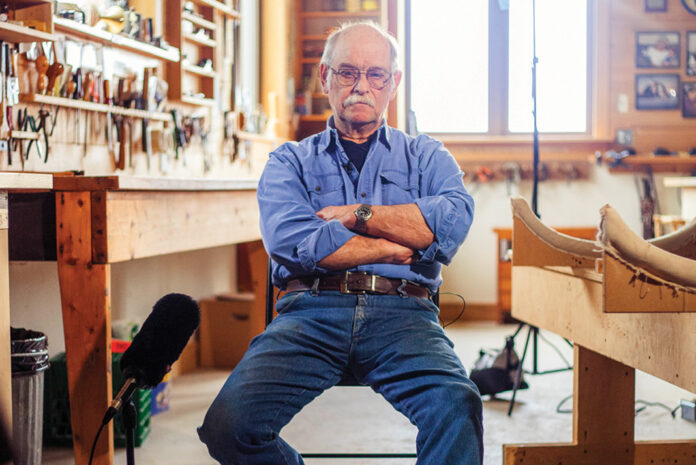 canoe-builder and author Ted Moores sits in his workshop at Bear Mountain Boats