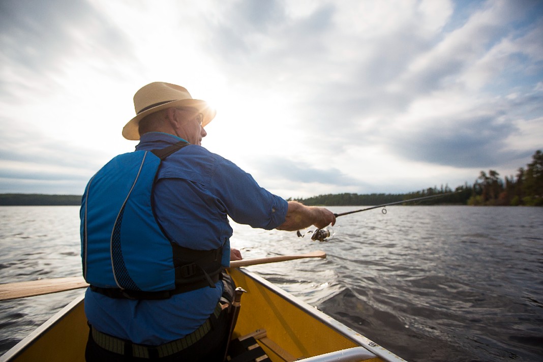 Fishing from canoe in the sun in Algonquin Park