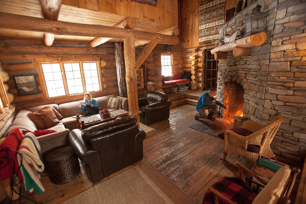 Interior of cabin with fireplace and couches