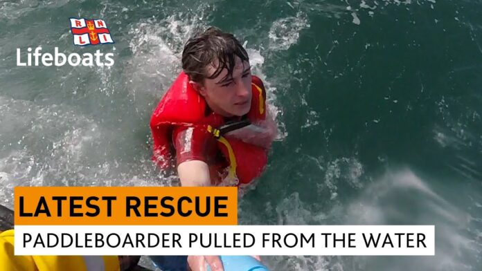 paddleboarder pulled from the water after calling for rescue on his cell phone