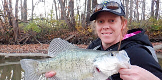 person holds up a crappie caught in fall with light tackle