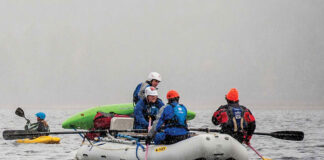 students on whitewater raft and kayak participate in a guide training program in the snow