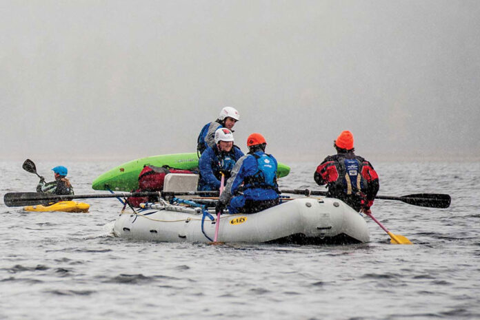 students on whitewater raft and kayak participate in a guide training program in the snow