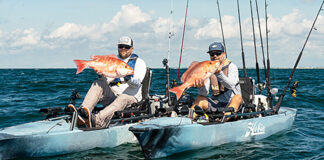 two anglers hold up fish caught on kayaks equipped with the Hobie MirageDrive 360
