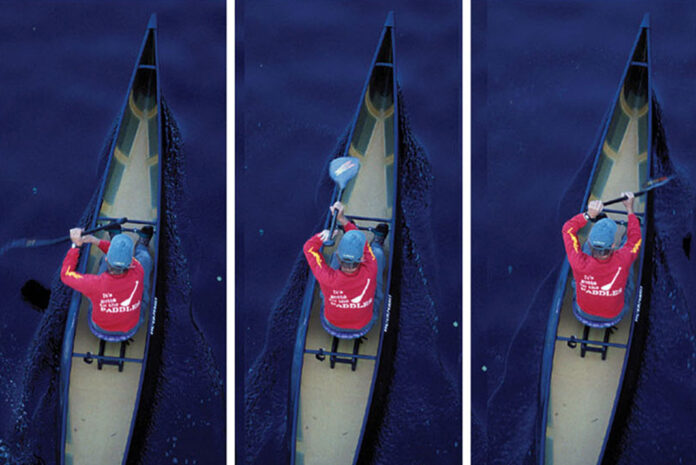 a canoeist practices the sit-and-switch paddling technique from the middle of a solo canoe