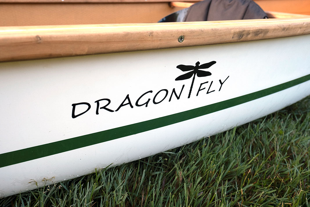 detail of the Dragonfly logo on the Stellar Dragonfly canoe as it sits on grass