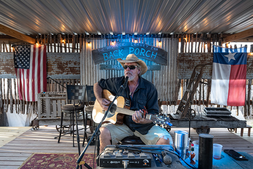 man plays guitar and sings at The Back Porch in Leakey, Texas