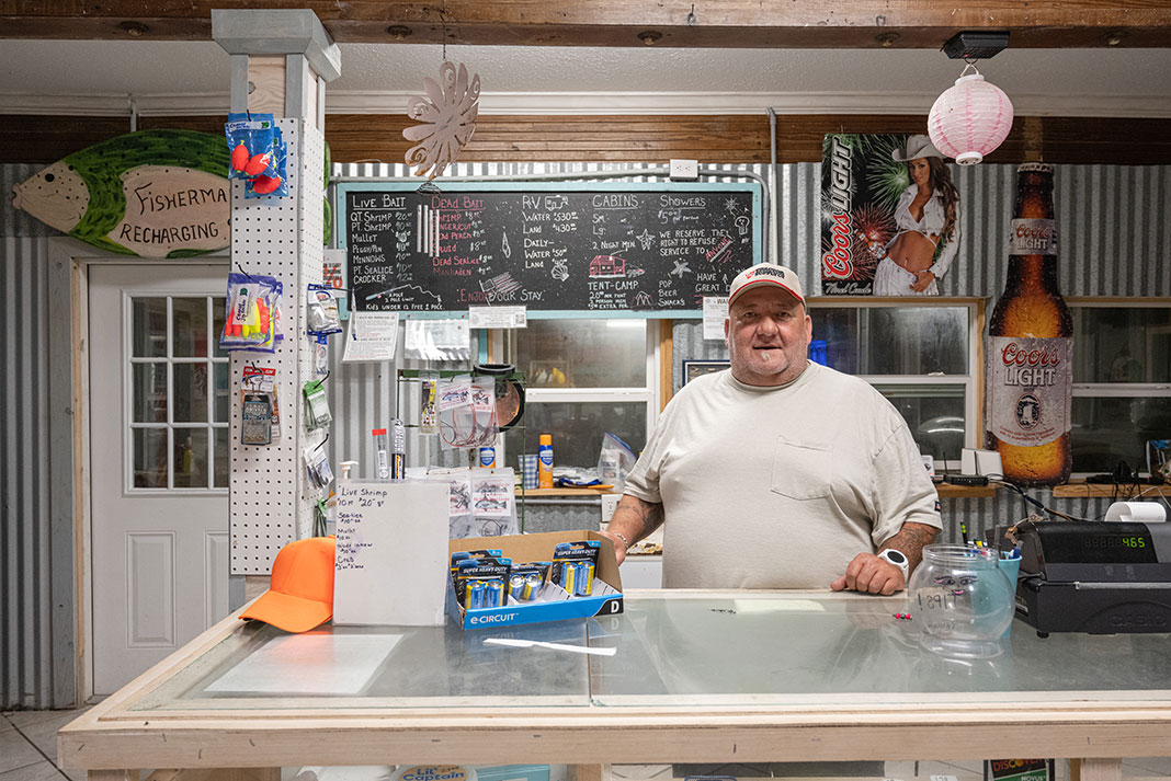 man stands behind the counter of a Texas bait shop