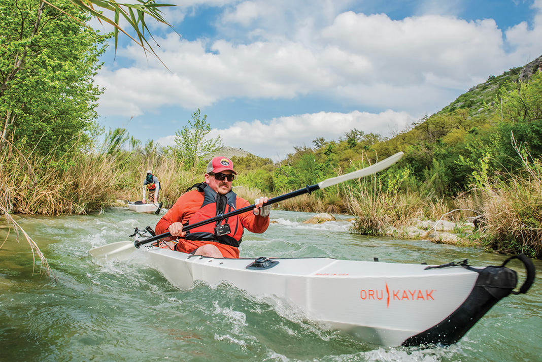 man paddles Oru kayak down the Devils River in Texas