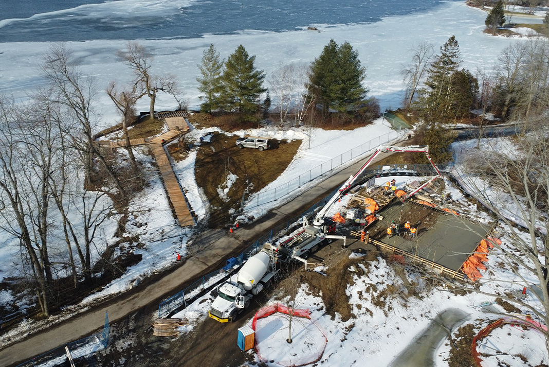 Aerial view of construction near frozen lake.