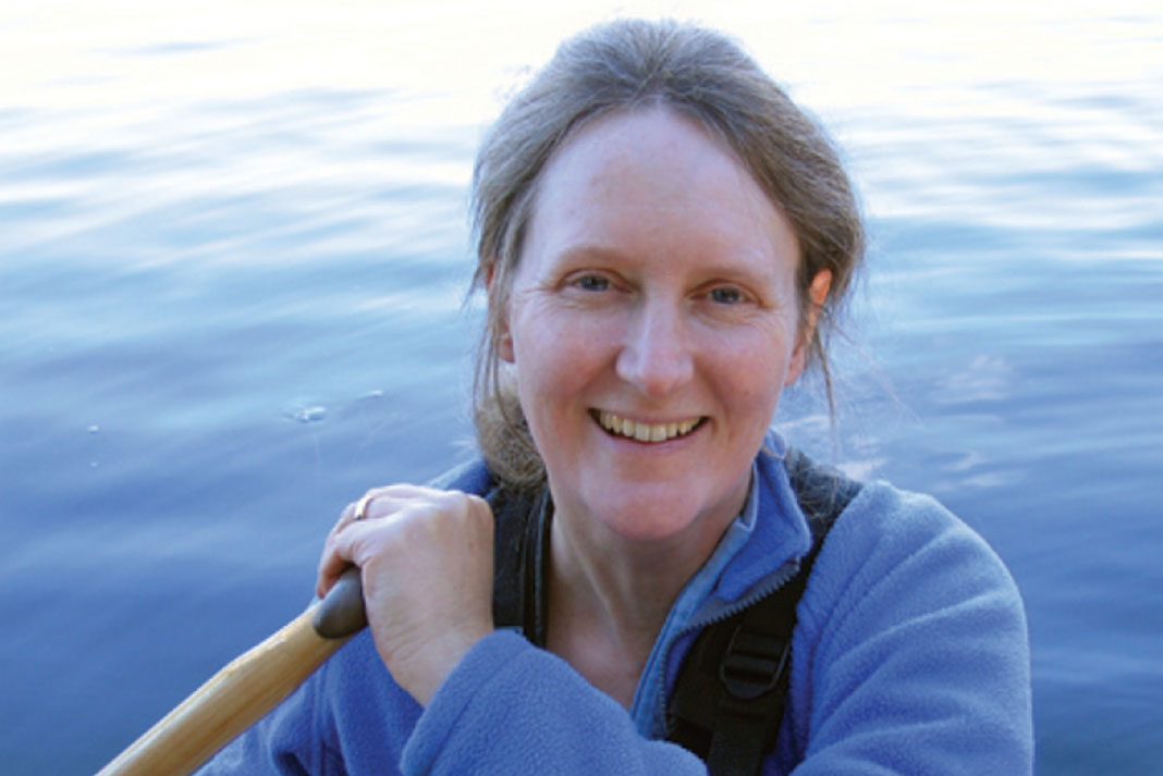 portrait of canoeist Becky Mason on the water with paddle in hand