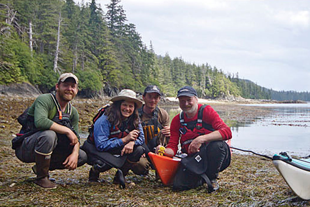 the Outer Island Survey team poses on an Alaskan beach