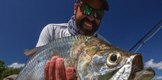 angler holds up a tarpon caught in the Florida Keys