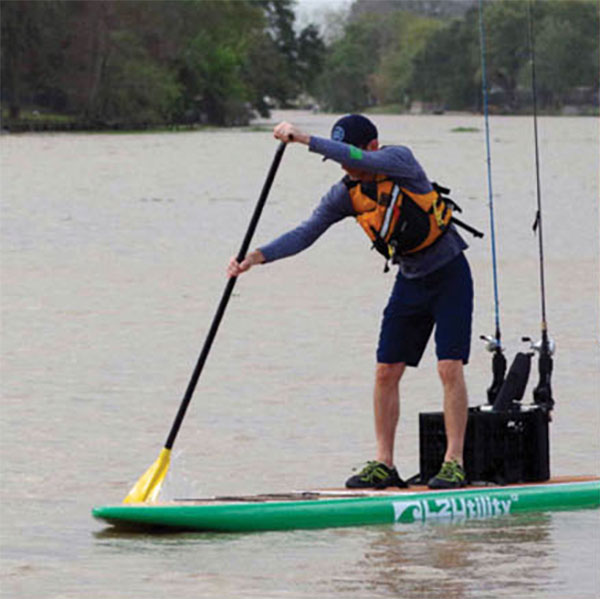 man demonstrates the forward stroke on a SUP