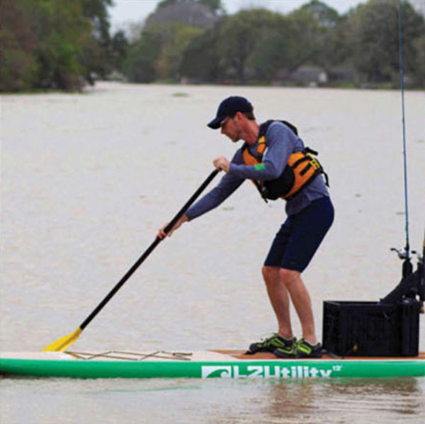 man demonstrates the reverse stroke on a SUP