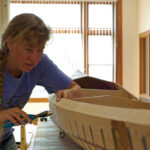 Workshop Confessions: What It’s Like To Build A Pygmy Kayak woman works on building a Pygmy Murrelet kayak in a workshop