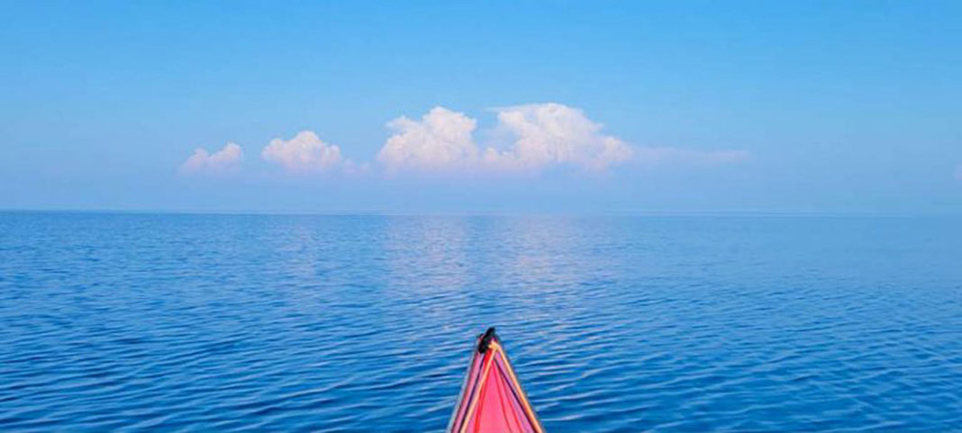 bow shot of red touring kayak on Lake Michigan