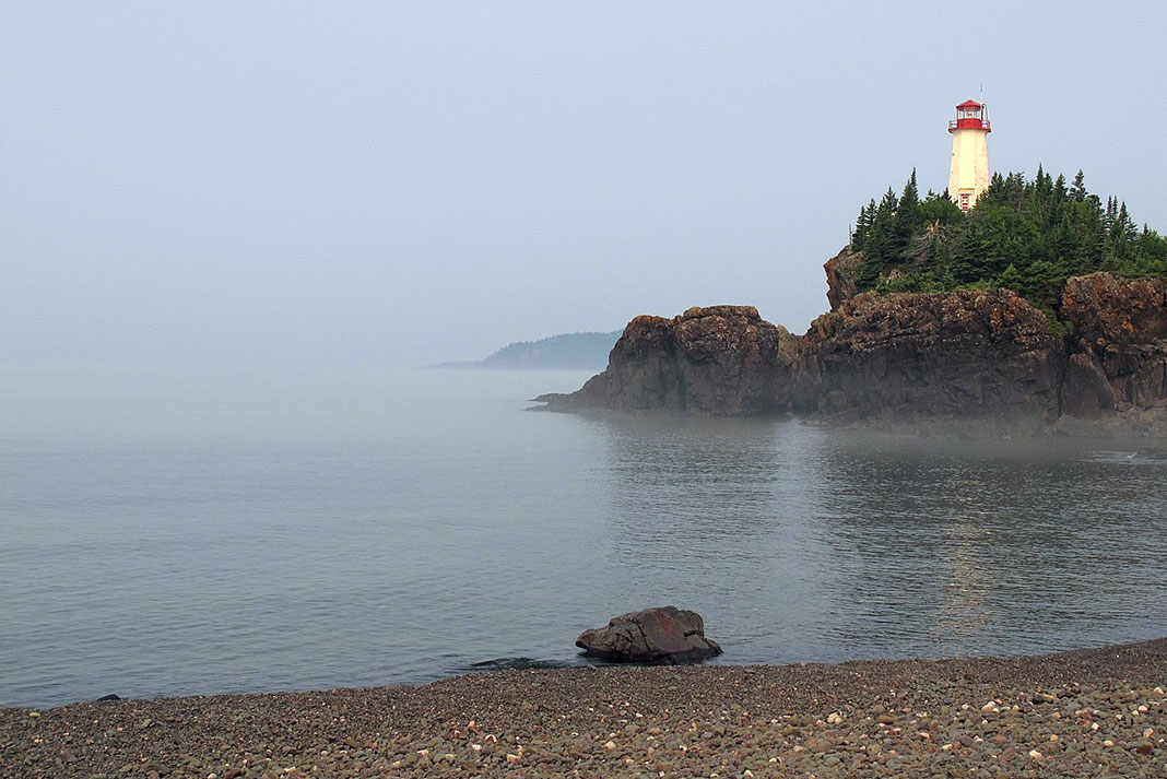Battle Island lighthouse looks out over the misty waters of Lake Superior