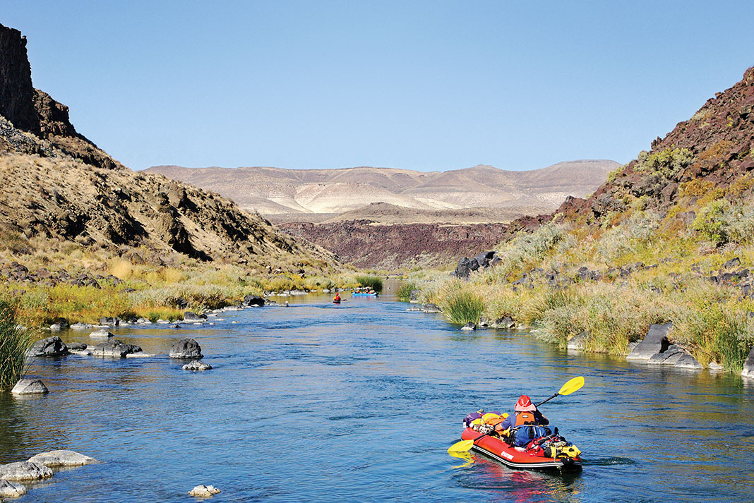 a group of kayakers paddling down the Owyhee River in Oregon