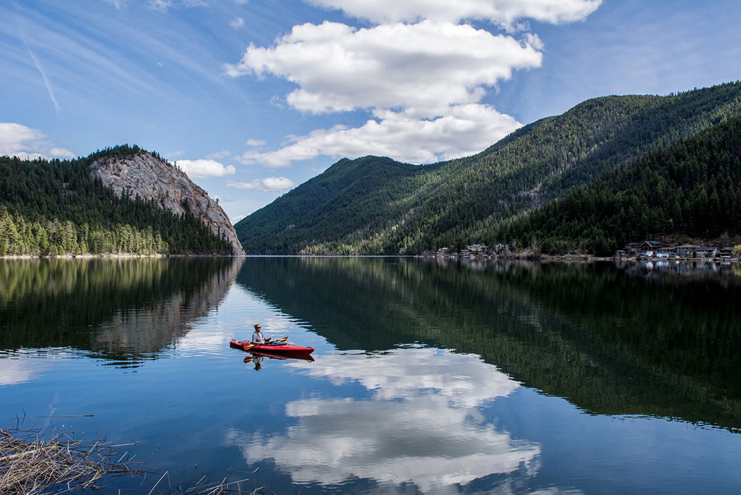 paddler and reflections over Paul Lake in British Columbia