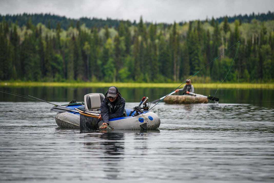 anglers in inflatable kayaks fish on Canim Lake in British Columbia's Cariboo region