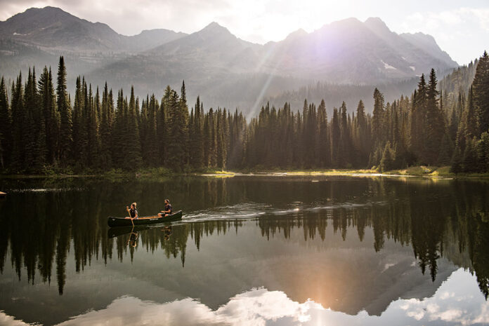 two people canoe on Island Lake near Fernie, BC