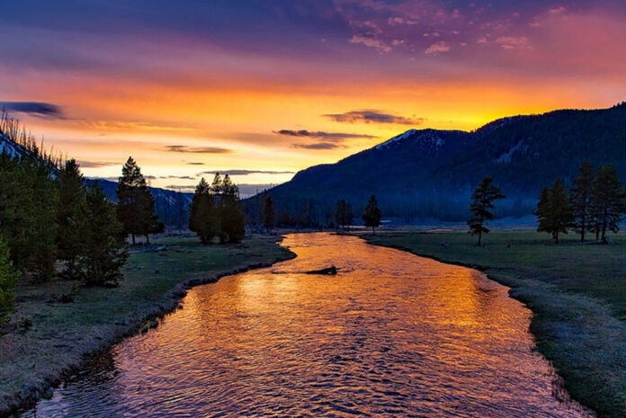 sunset over a river in Yellowstone National Park