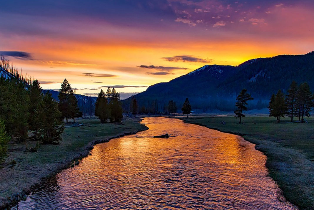 sunset over a river in Yellowstone National Park