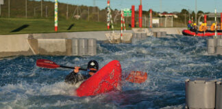 a kayaker plays in whitewater at Vector Wero Whitewater Park in Auckland, home to to the world's first raftable artificial waterfall