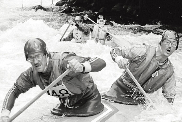 tandem kayakers race through the whitewater course on the Gull River