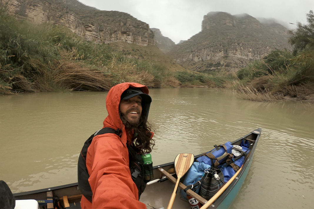 Man takes selfie from canoe.