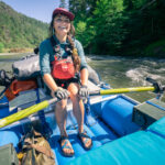 Two Iconic River Brands Release Sandal Collaboration To Benefit A Noble Mission Person rowing raft wearing Chaco x NRS sandals