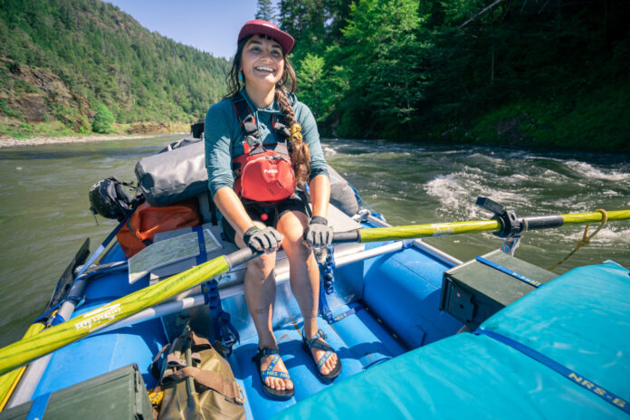 Person rowing raft wearing Chaco x NRS sandals