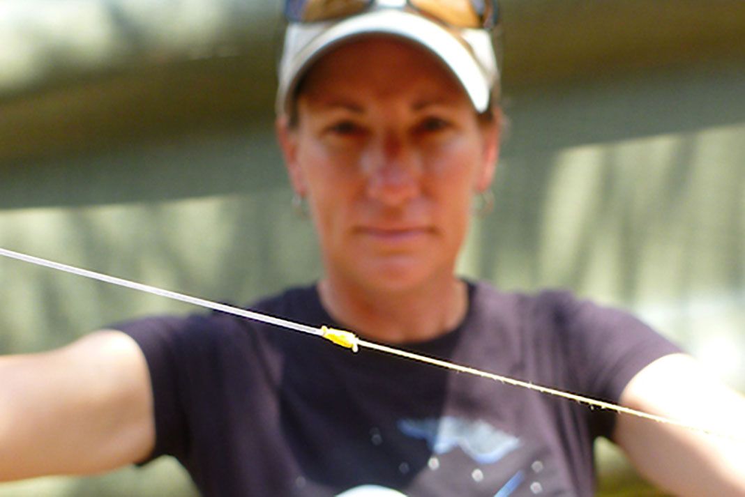 woman holds up a fishing knot
