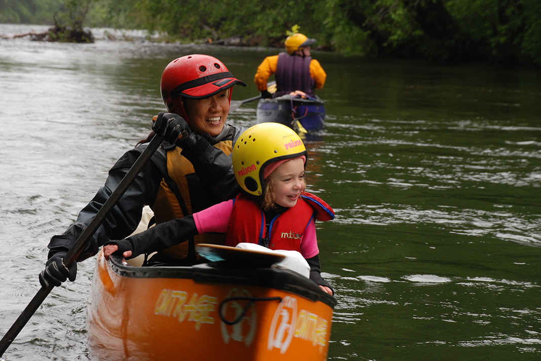 Mom and daughter in a whitewater canoe