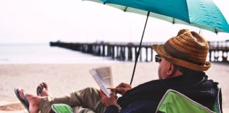 Man reading on the beach.