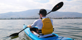 man paddles a sit in kayak from Delta Kayaks