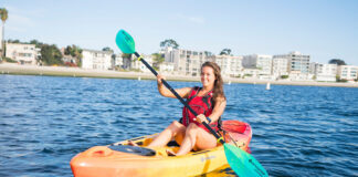 woman paddles in a sit on top kayak from Perception