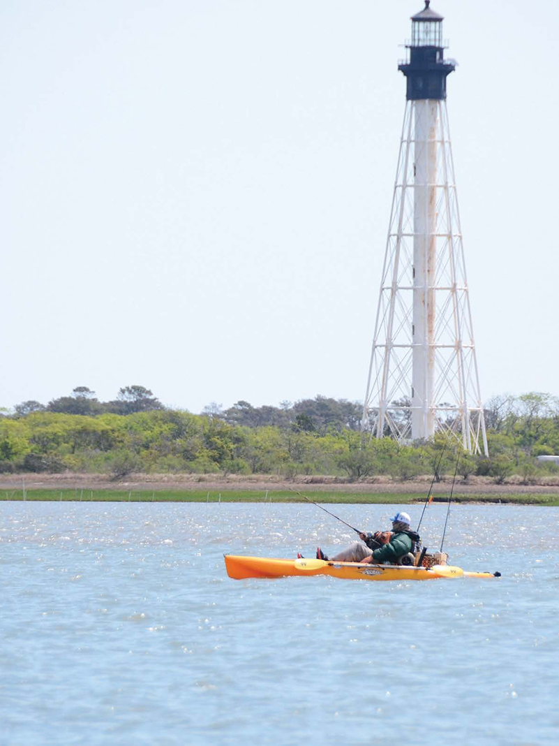 kayak angler uses landmarks along the shore to help with coastal navigation