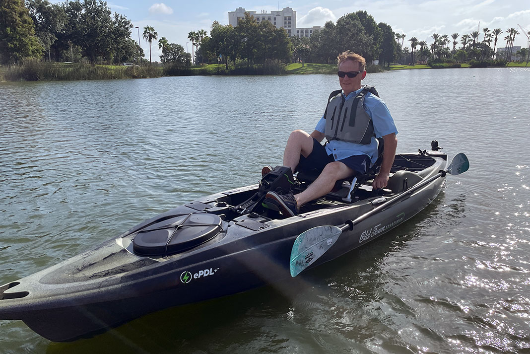 man tests out pedaling the Old Town BigWater ePDL+ 132 kayak at ICAST 2023 demo day