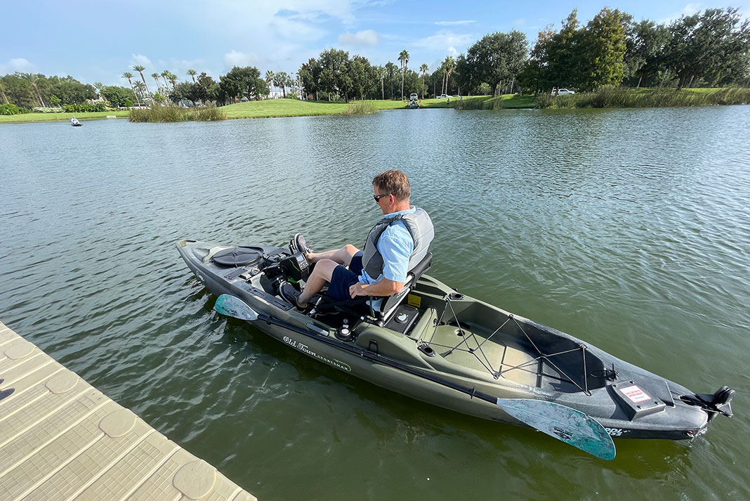 man tests out pedaling the Old Town ePDL kayak at ICAST 2023 demo day