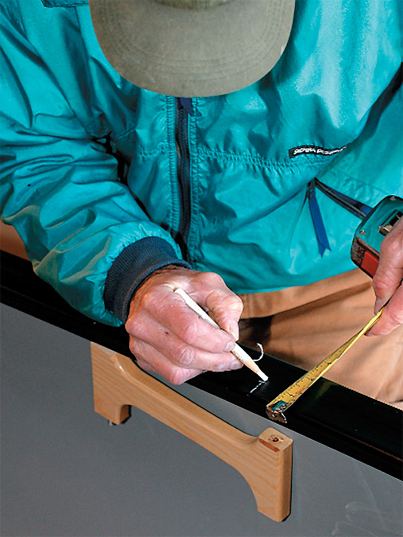 man installing the stern seat in a whitewater tripping canoe